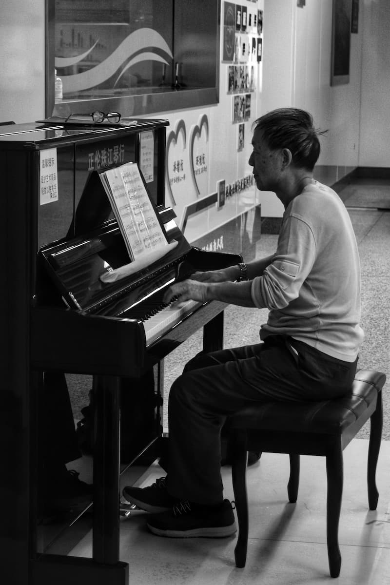 A man practicing piano at a metro station.